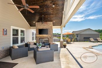 Outdoor pavilion with fireplace, flat screen tv, and food area